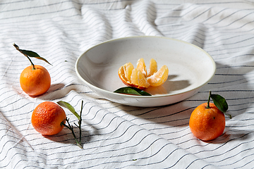 Image showing still life with mandarins on plate over drapery