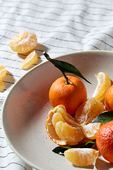 Image showing still life with mandarins on plate over drapery