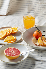 Image showing mandarin, grapefruit and glass of orange juice