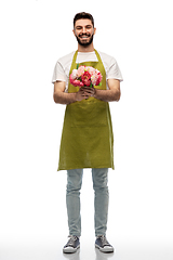 Image showing smiling male gardener with bunch of peony flowers