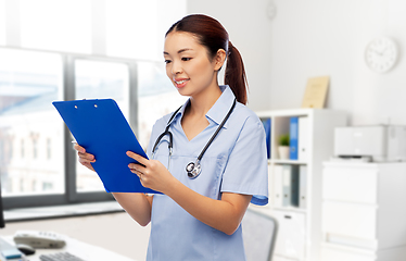 Image showing asian female doctor with clipboard at hospital