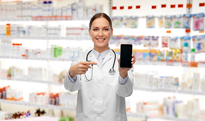 Image showing happy female doctor or nurse with smartphone