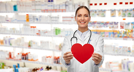 Image showing smiling female doctor with heart and stethoscope