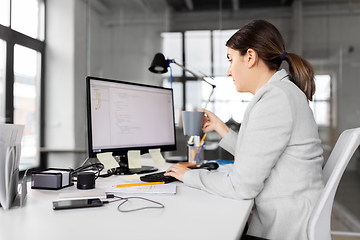 Image showing businesswoman with computer and coffee at office