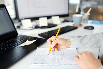 Image showing businesswoman with notebook and laptop at office