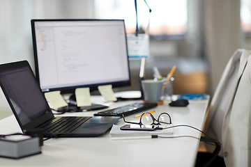 Image showing laptop computer and gadgets on table at office