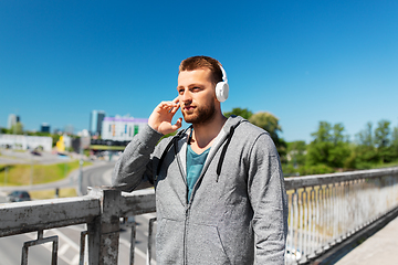 Image showing man in headphones listening to music outdoors