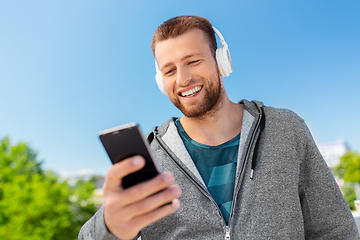 Image showing young man with headphones and smartphone