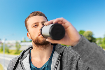 Image showing young man with sports bottle