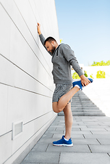 Image showing man stretching leg outdoors