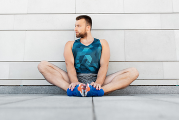 Image showing man doing sports and stretching outdoors