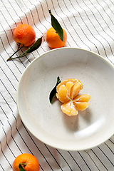 Image showing still life with mandarins on plate over drapery