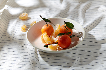 Image showing still life with mandarins on plate over drapery