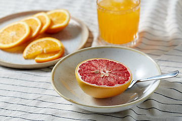 Image showing grapefruit, sliced orange and glass of juice