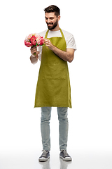 Image showing smiling male gardener with bunch of peony flowers