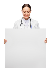 Image showing happy smiling female doctor holding white board