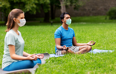 Image showing group of people doing yoga at summer park