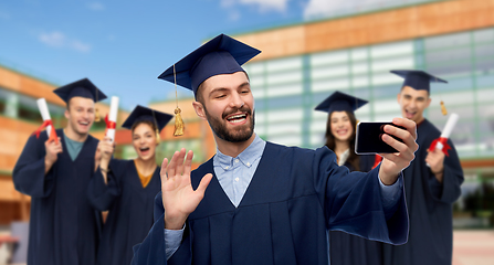 Image showing male graduate student with smartphone takes selfie