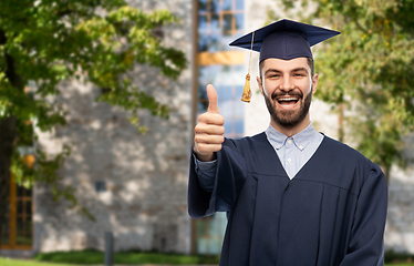 Image showing happy male graduate student showing thumbs up