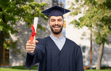 Image showing male graduate student in mortar board with diploma