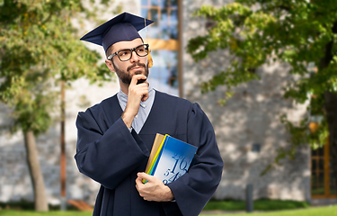 Image showing thoughtful graduate student or bachelor with books