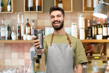 Image showing happy waiter with tumbler or takeaway thermo cup