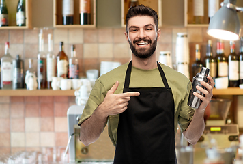 Image showing happy barman with shaker preparing