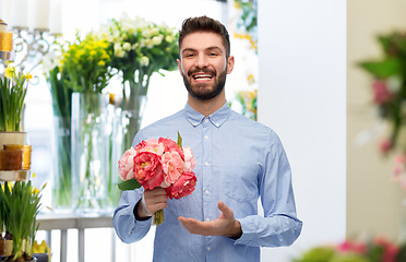 Image showing happy smiling man with bunch of flowers