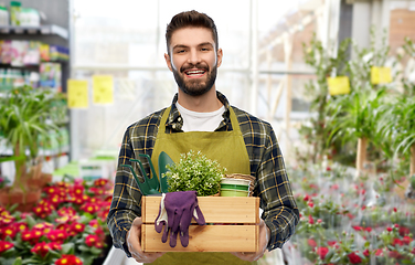 Image showing happy gardener or seller with box of garden tools