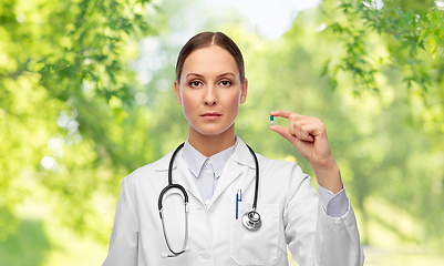 Image showing female doctor holding medicine pill