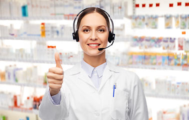 Image showing smiling female doctor with headset at pharmacy