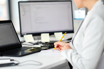 Image showing businesswoman with notebook and laptop at office