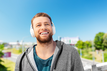 Image showing man in headphones listening to music outdoors