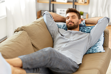 Image showing young man sleeping on sofa at home