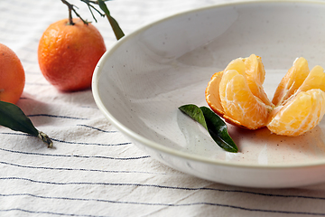 Image showing still life with mandarins on plate over drapery