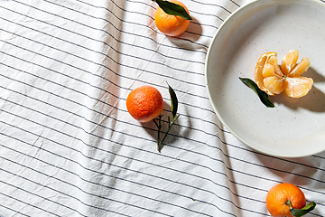 Image showing still life with mandarins on plate over drapery