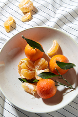 Image showing still life with mandarins on plate over drapery