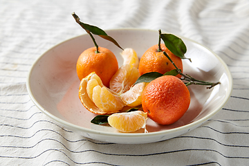 Image showing still life with mandarins on plate over drapery