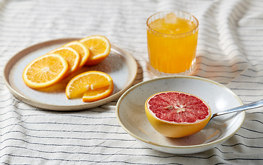 Image showing grapefruit, sliced orange and glass of juice