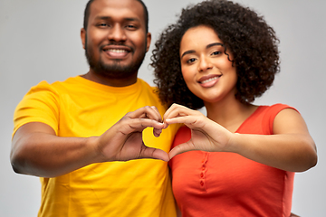 Image showing happy african american couple making hand heart