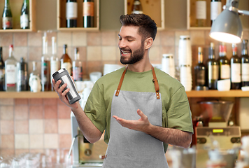 Image showing happy waiter with tumbler or takeaway thermo cup