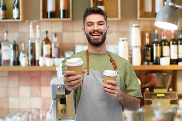 Image showing happy smiling barman in apron with takeaway coffee