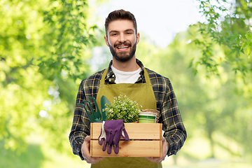 Image showing happy gardener or farmer with box of garden tools