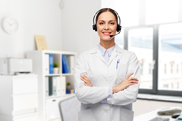 Image showing smiling female doctor with headset at hospital