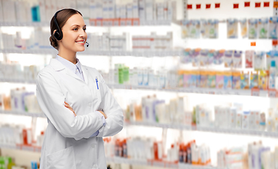 Image showing smiling female doctor with headset at pharmacy