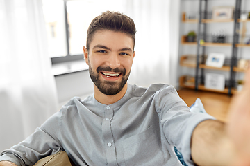 Image showing man taking selfie or having video call at home
