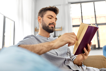 Image showing man reading book at home