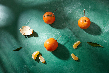 Image showing still life with mandarins on green background