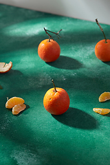 Image showing still life with mandarins on green background