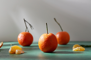 Image showing still life with mandarins on green background